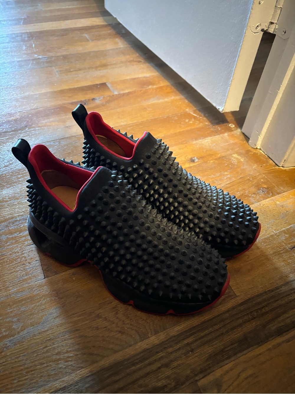 Christian Louboutin Black Studded Slip-On Sneakers with Red Accents